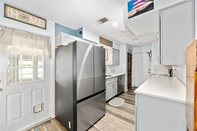 a kitchen with stainless steel appliances a refrigerator and a sink