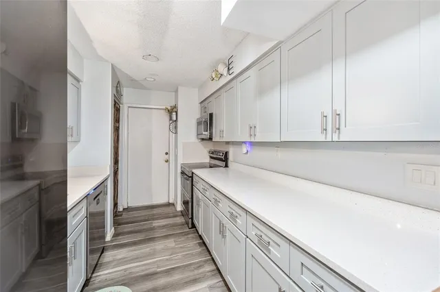 a kitchen with a sink and refrigerator