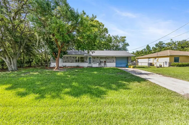 a front view of house with yard and green space