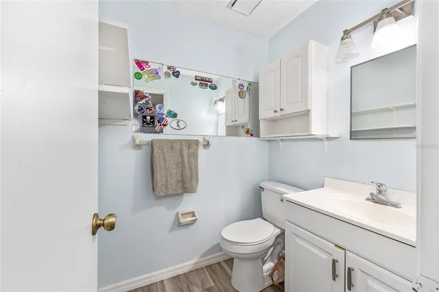 a bathroom with a sink toilet and mirror