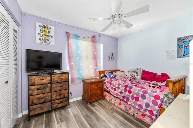 a bedroom with a bed and flat screen tv