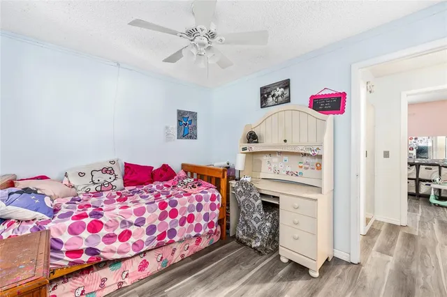 a bedroom with a bed a couch and dresser