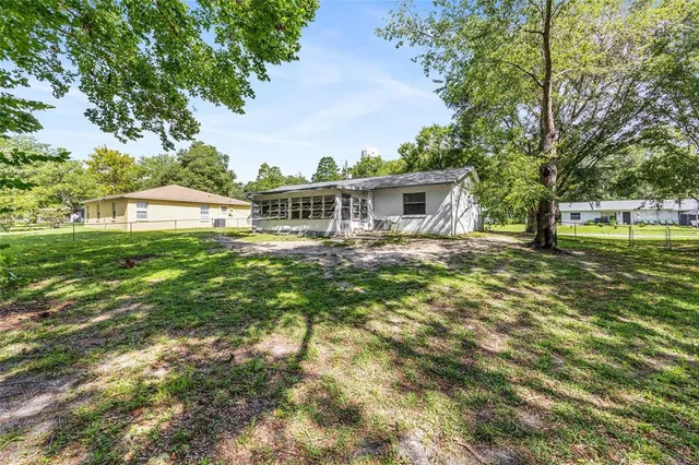 a house view with swimming pool and garden space