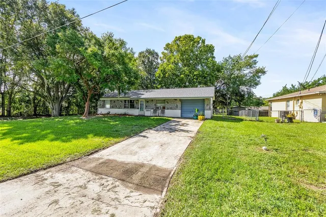 a front view of house with yard and green space