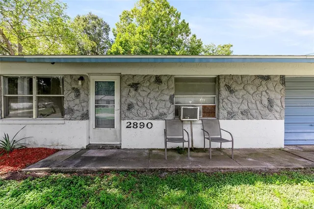 a view of front door and small yard