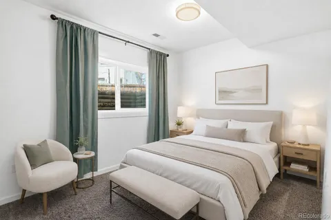 a bedroom with a bed and a couch