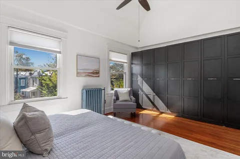 a living room with a couch a window and a chandelier
