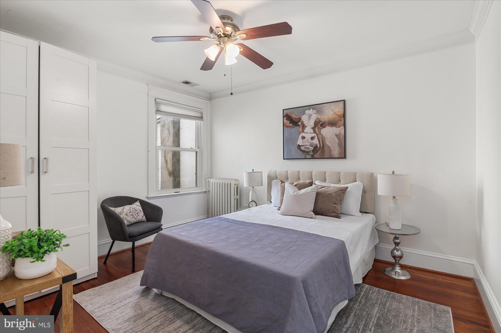 1309 Spring Road Northwest Washington, DC 20010 - Photo 12 of 22 a bedroom with a bed and a chair