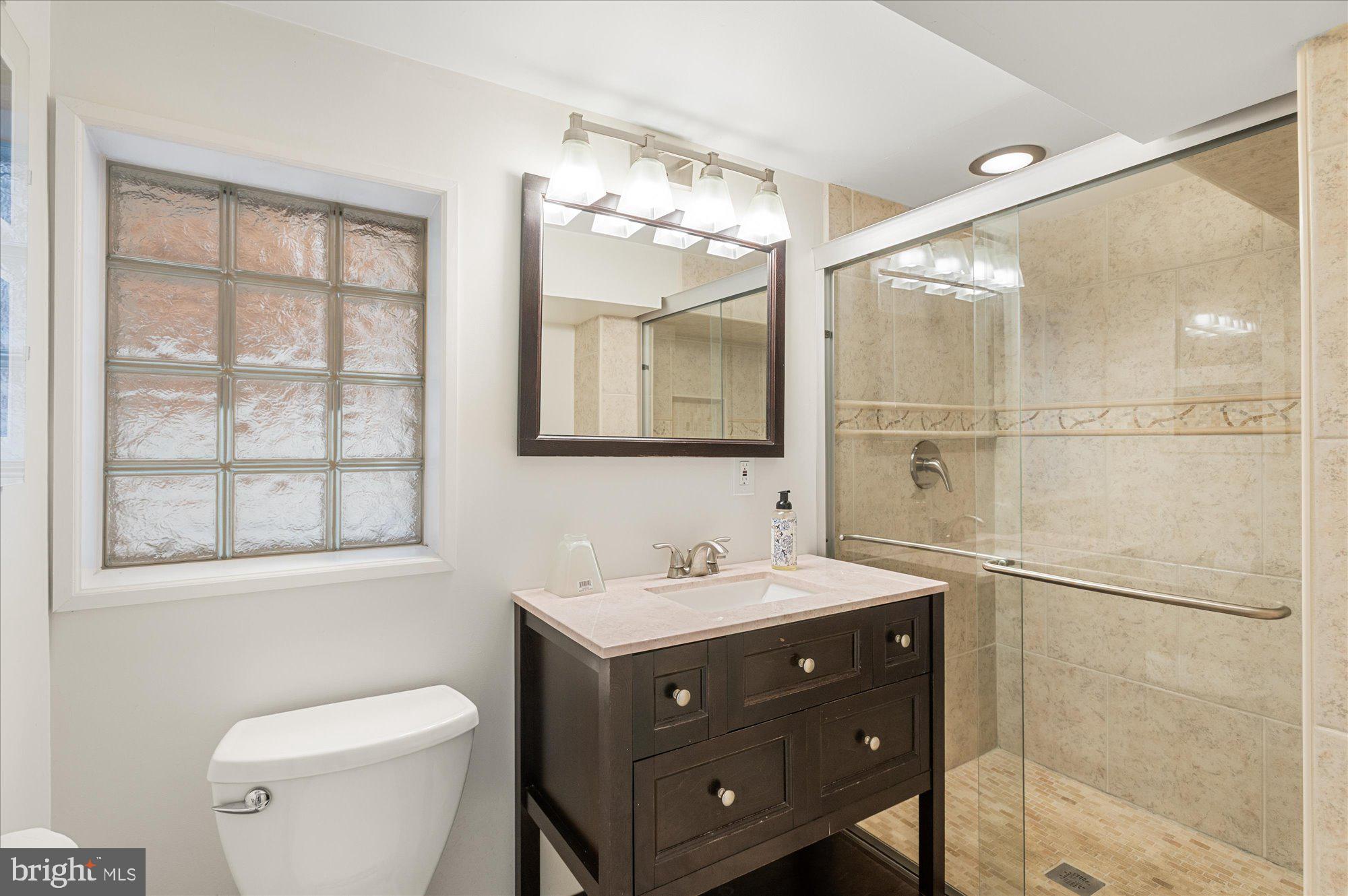 1309 Spring Road Northwest Washington, DC 20010 - Photo 18 of 22 a bathroom with a sink vanity mirror and toilet