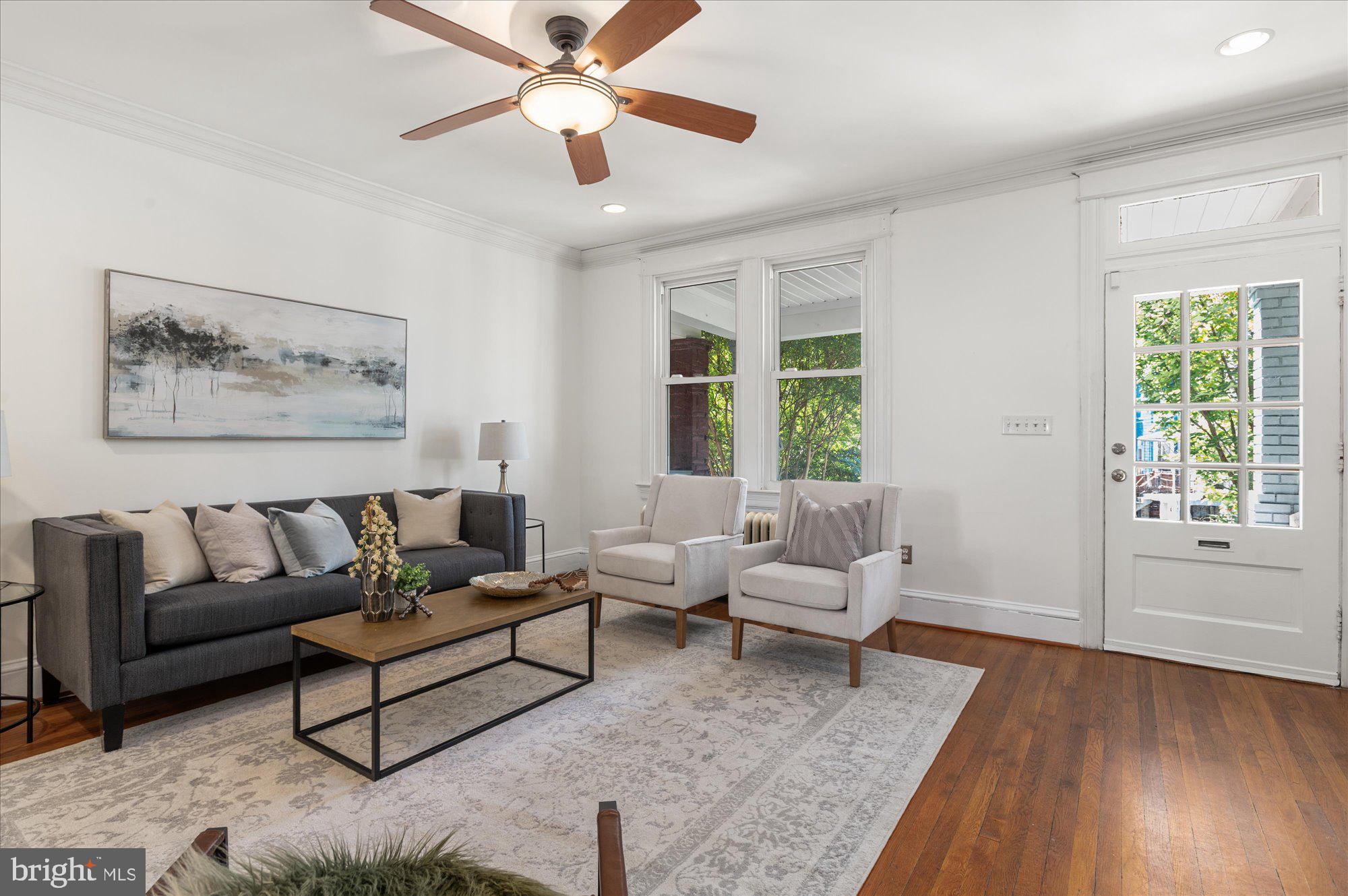 1309 Spring Road Northwest Washington, DC 20010 - Photo 4 of 22 a living room with furniture and a large window