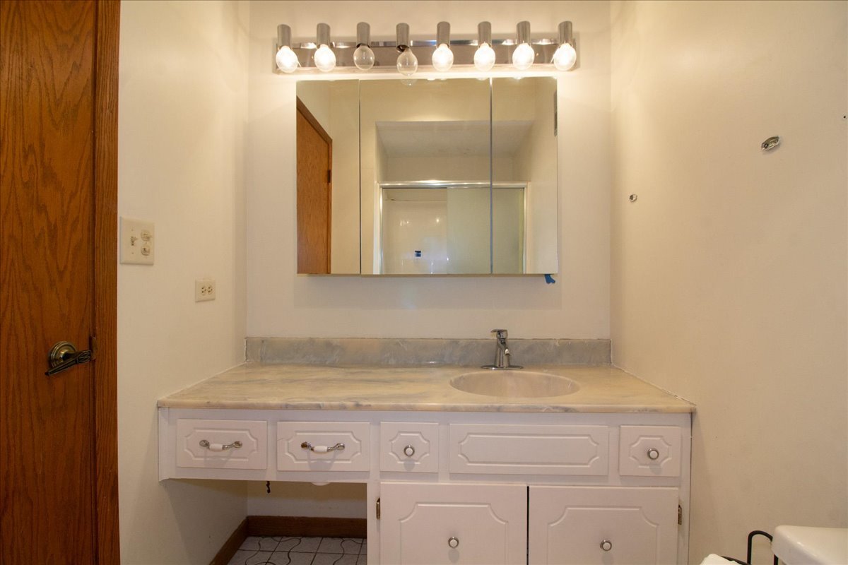 1424 Woodbridge Road, Unit 2C Joliet, IL 60436 - Photo 14 of 20 a bathroom with a sink and a mirror