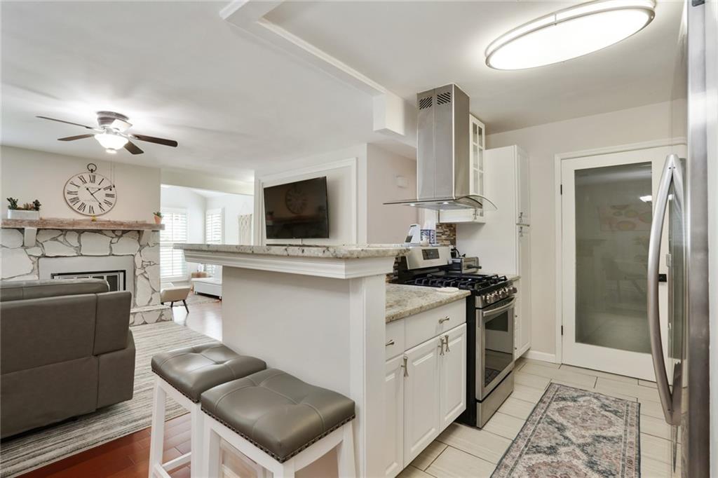3210 Lake Pointe Circle Roswell, GA 30075 - Photo 11 of 26 a kitchen with stainless steel appliances a stove a sink and a refrigerator