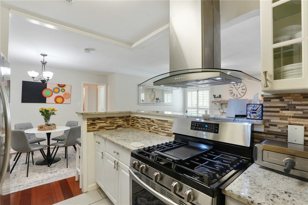 3210 Lake Pointe Circle Roswell, GA 30075 - Photo 13 of 26 a kitchen with stainless steel appliances granite countertop a stove and a sink