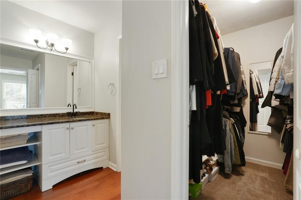 3210 Lake Pointe Circle Roswell, GA 30075 - Photo 17 of 26 a view of walk in closet with clothes and shoes