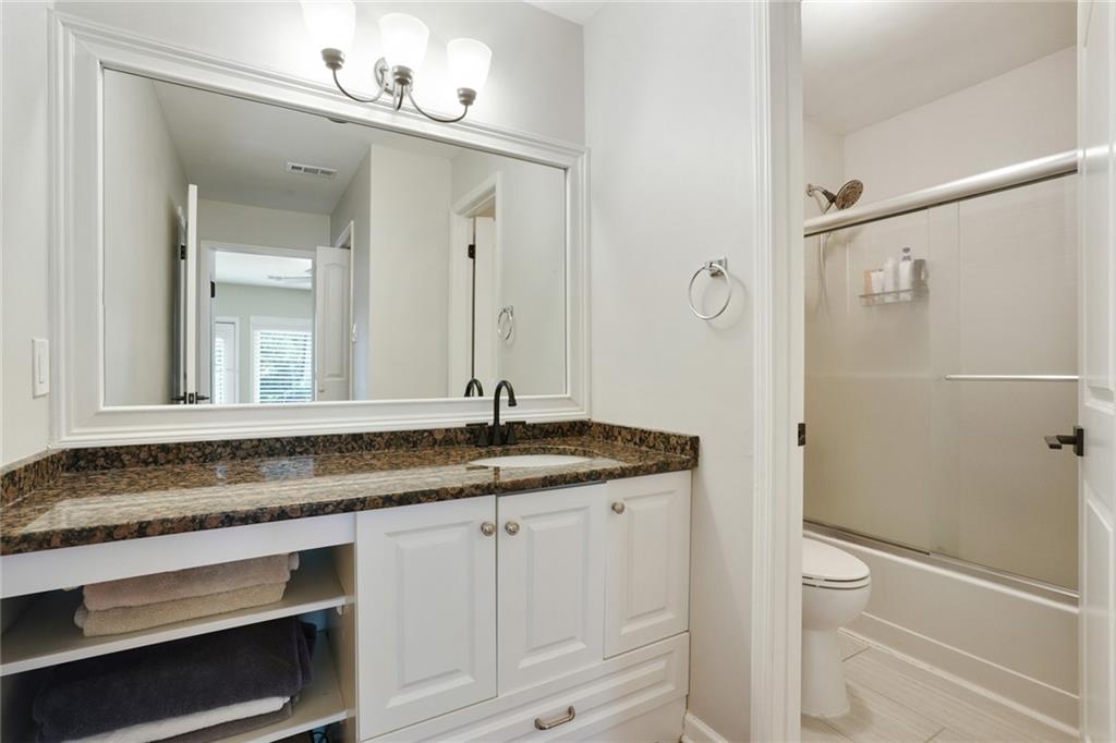 3210 Lake Pointe Circle Roswell, GA 30075 - Photo 18 of 26 a bathroom with a granite countertop sink and a mirror