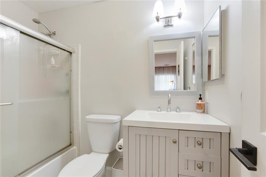 3210 Lake Pointe Circle Roswell, GA 30075 - Photo 20 of 26 a bathroom with a sink a toilet and a mirror