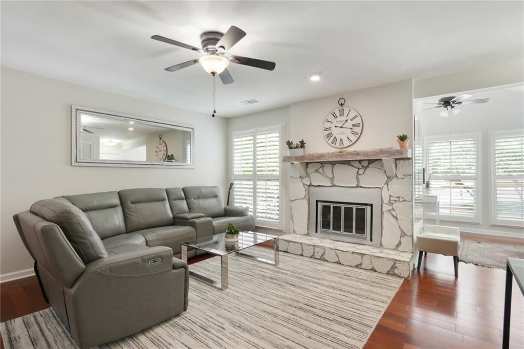3210 Lake Pointe Circle Roswell, GA 30075 - Photo 4 of 26 a living room with furniture a fireplace and a large window