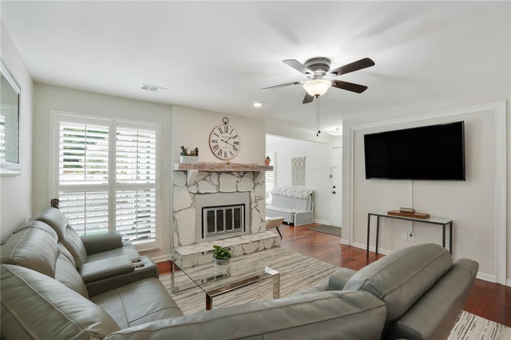 3210 Lake Pointe Circle Roswell, GA 30075 - Photo 6 of 26 a living room with furniture a flat screen tv and a fireplace