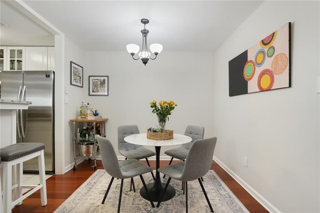 3210 Lake Pointe Circle Roswell, GA 30075 - Photo 9 of 26 a view of a dining room with furniture a rug and wooden floor