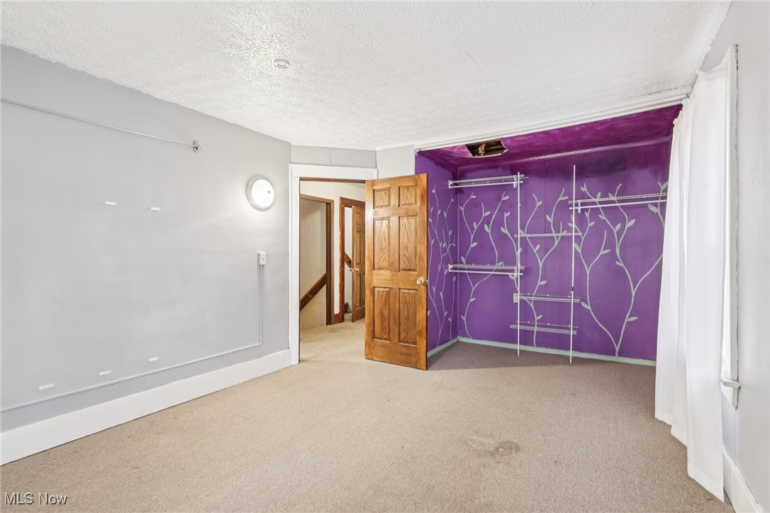 764 Chalker Street Akron, OH 44310 - Photo 20 of 34 Unfurnished bedroom with a textured ceiling, carpet floors, and a closet