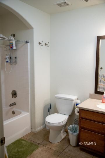 1017 Porter Street Ridgecrest, CA 93555 - Photo 12 of 15 a bathroom with a toilet a sink and bathtub