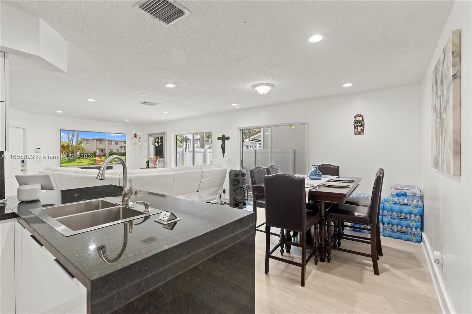 5301 Southwest 126th Terrace, Unit 5301 Miramar, FL 33027 - Photo 11 of 37 a view of a dining room with furniture and wooden floor