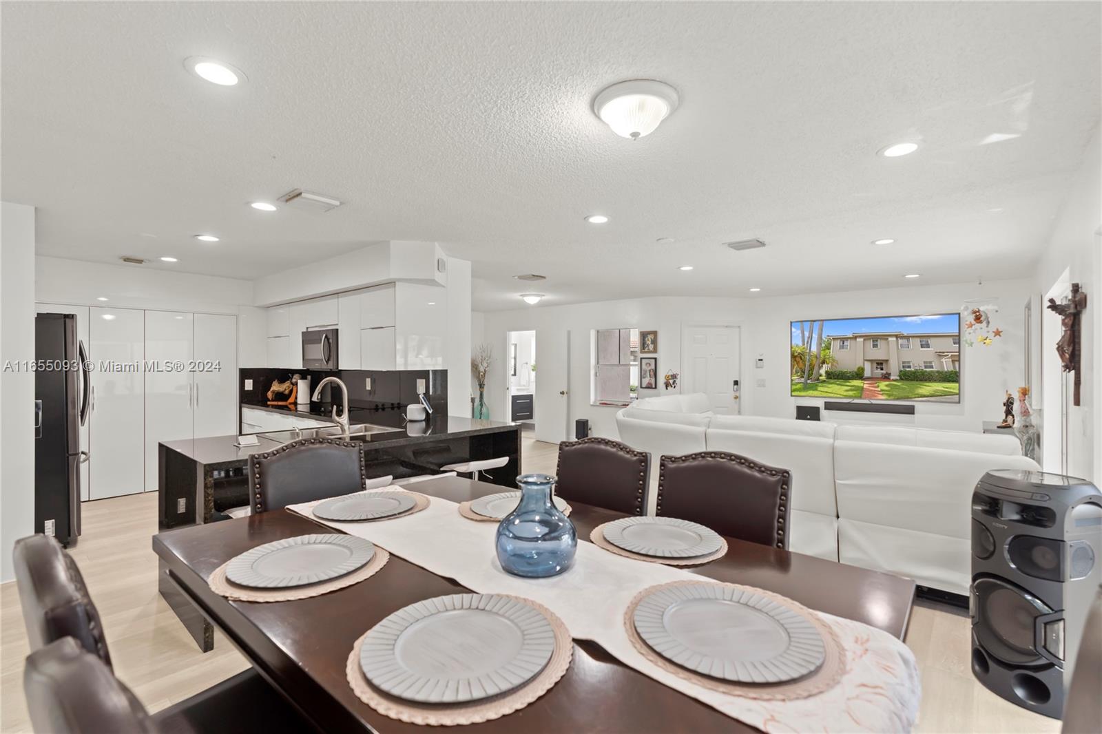 5301 Southwest 126th Terrace, Unit 5301 Miramar, FL 33027 - Photo 13 of 37 a kitchen with stainless steel appliances kitchen island granite countertop a dining table and chairs