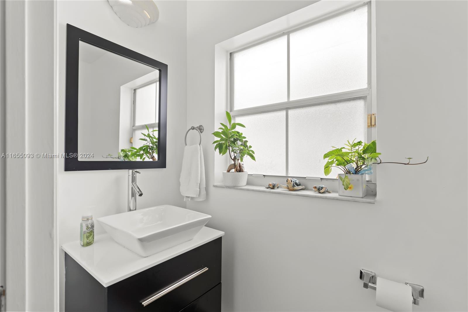 5301 Southwest 126th Terrace, Unit 5301 Miramar, FL 33027 - Photo 15 of 37 a bathroom with a sink and a mirror