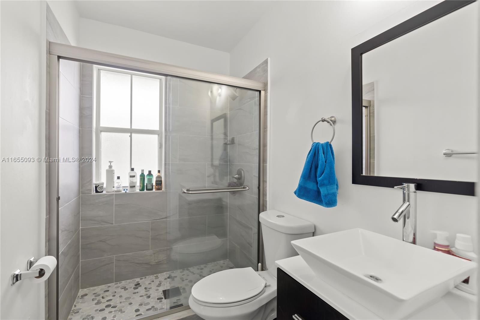 5301 Southwest 126th Terrace, Unit 5301 Miramar, FL 33027 - Photo 18 of 37 a bathroom with a sink toilet and shower