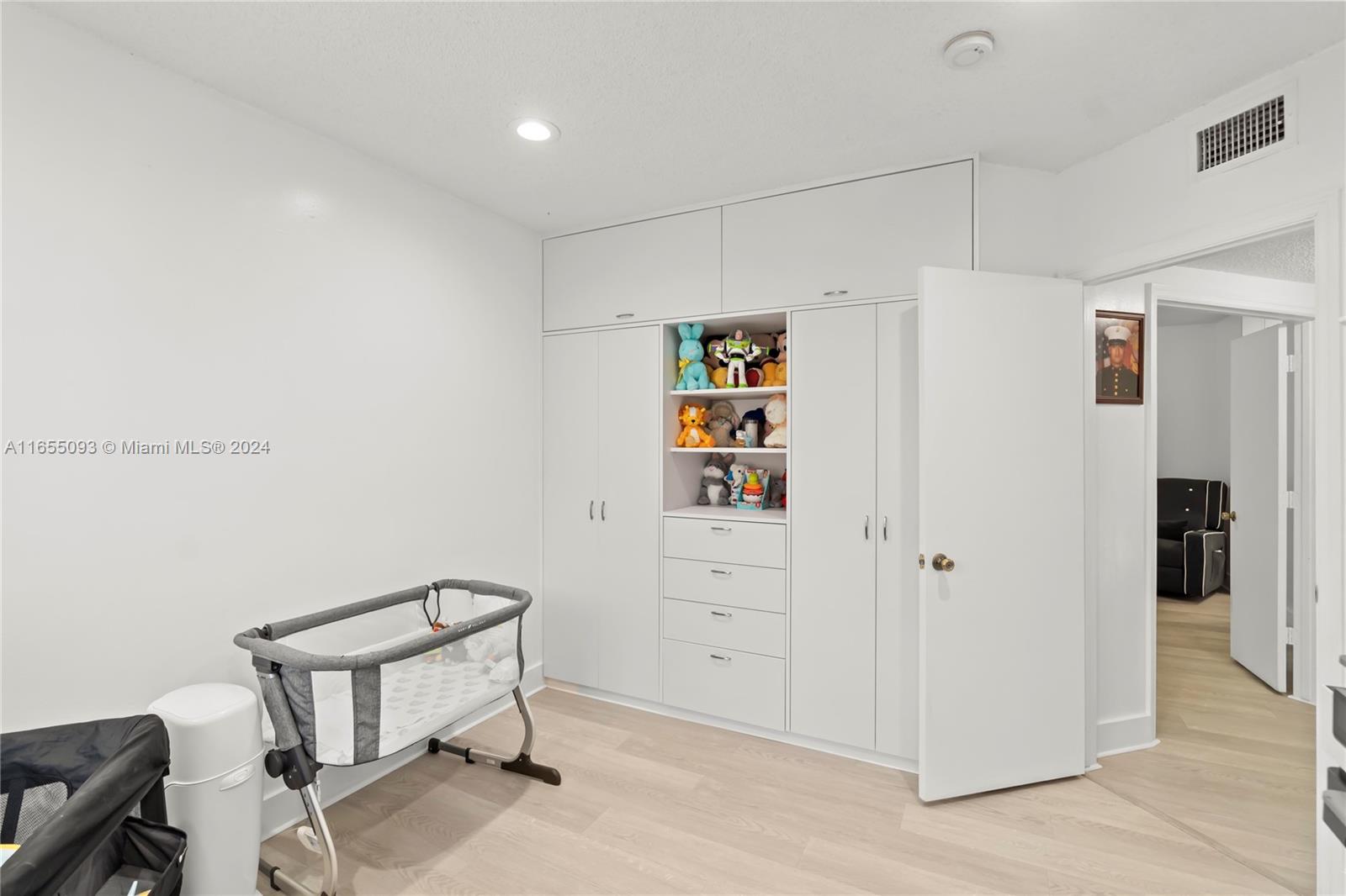 5301 Southwest 126th Terrace, Unit 5301 Miramar, FL 33027 - Photo 19 of 37 a view of room with hardwood wall and closet