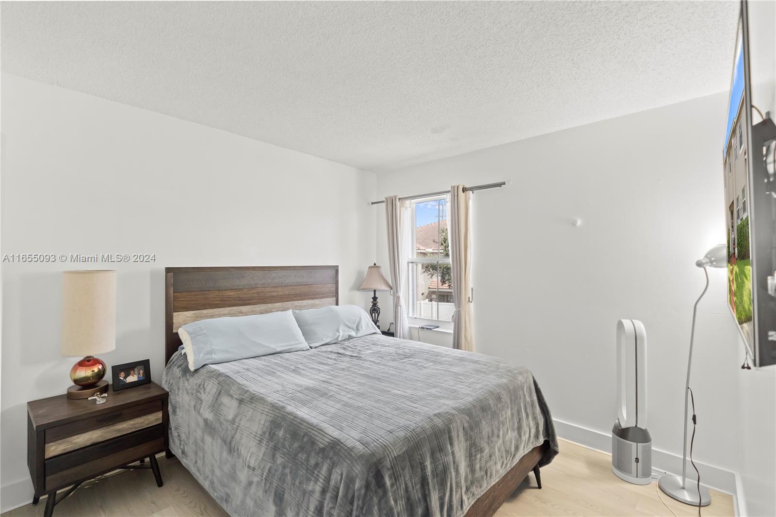 5301 Southwest 126th Terrace, Unit 5301 Miramar, FL 33027 - Photo 20 of 37 a bedroom with a bed and a couch