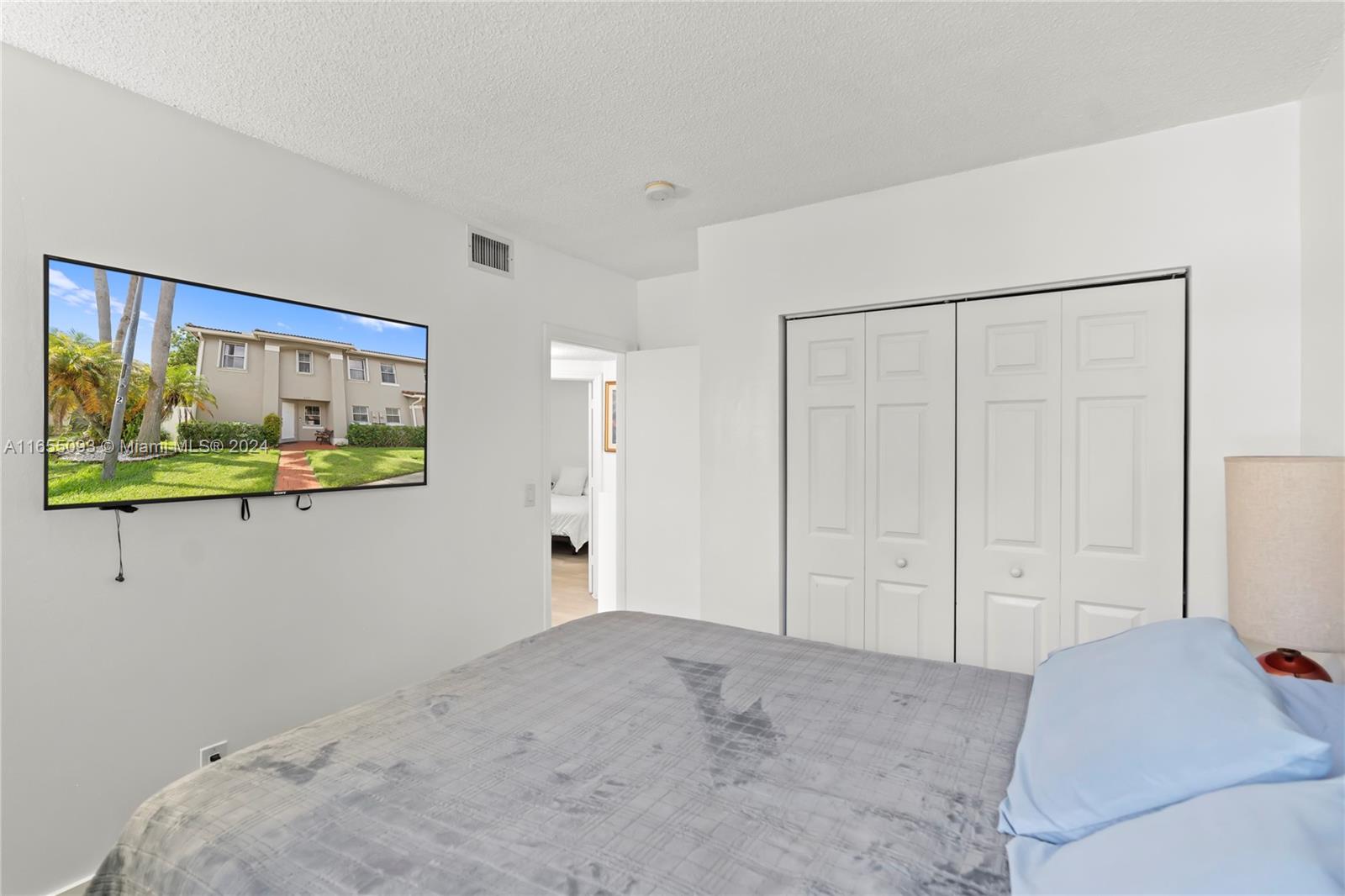 5301 Southwest 126th Terrace, Unit 5301 Miramar, FL 33027 - Photo 21 of 37 a bedroom with a bed and painting on the wall