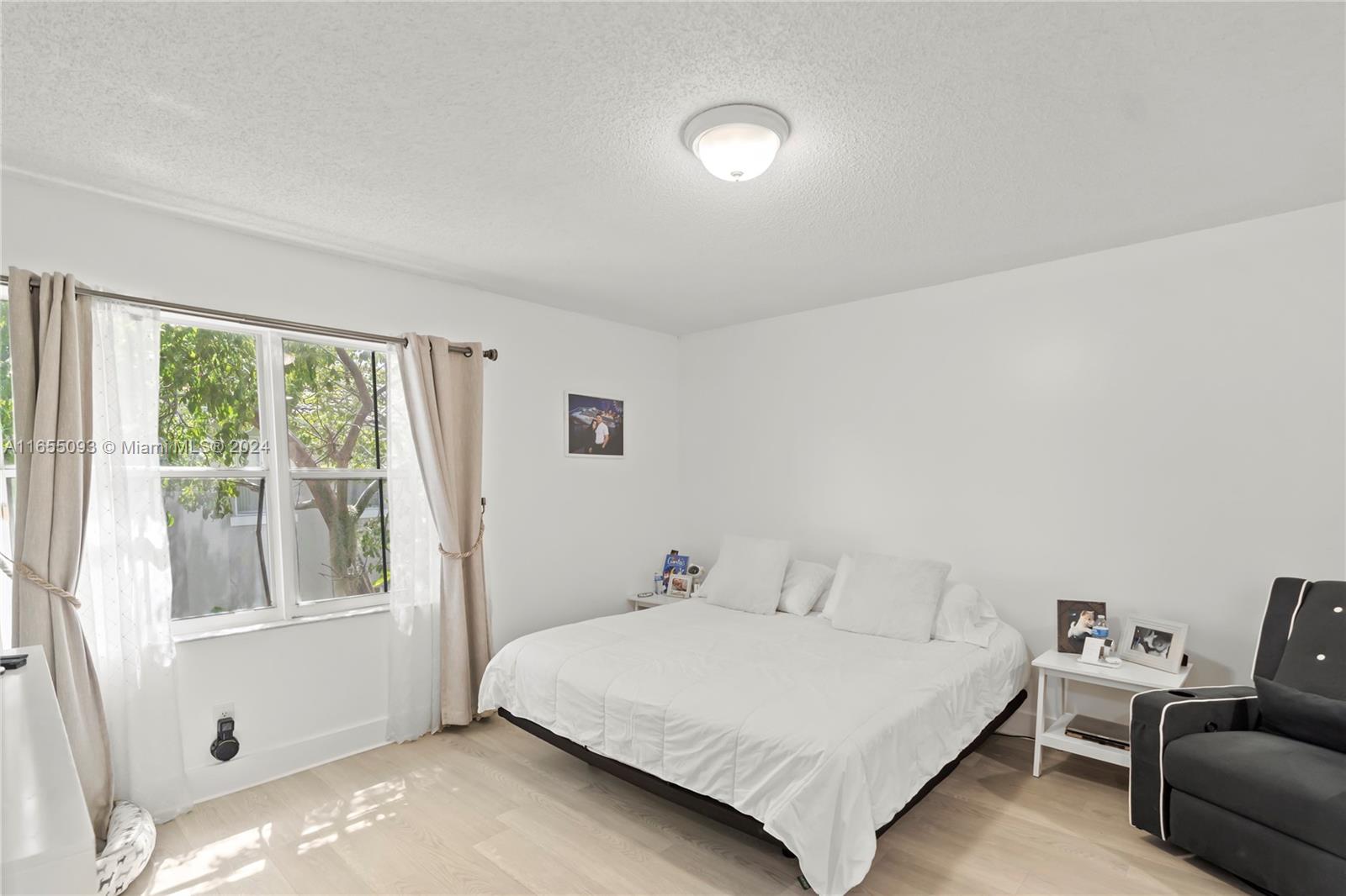 5301 Southwest 126th Terrace, Unit 5301 Miramar, FL 33027 - Photo 22 of 37 a bedroom with a bed and a large window