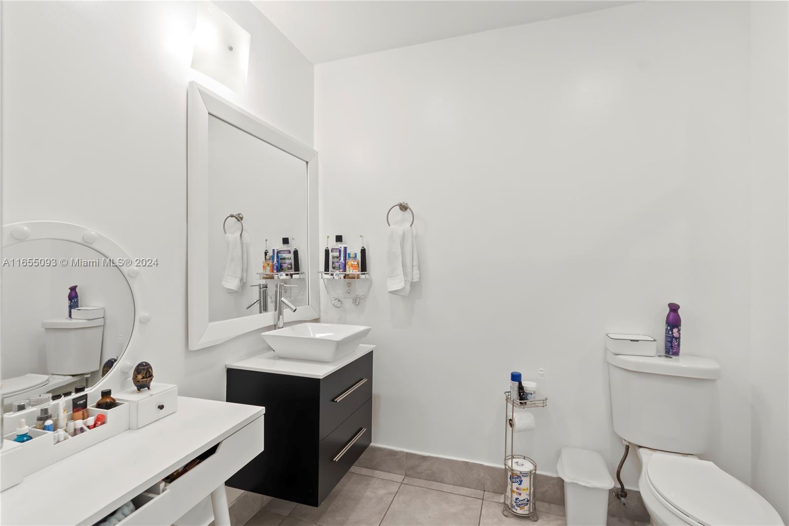 5301 Southwest 126th Terrace, Unit 5301 Miramar, FL 33027 - Photo 27 of 37 a bathroom with a sink vanity and a toilet