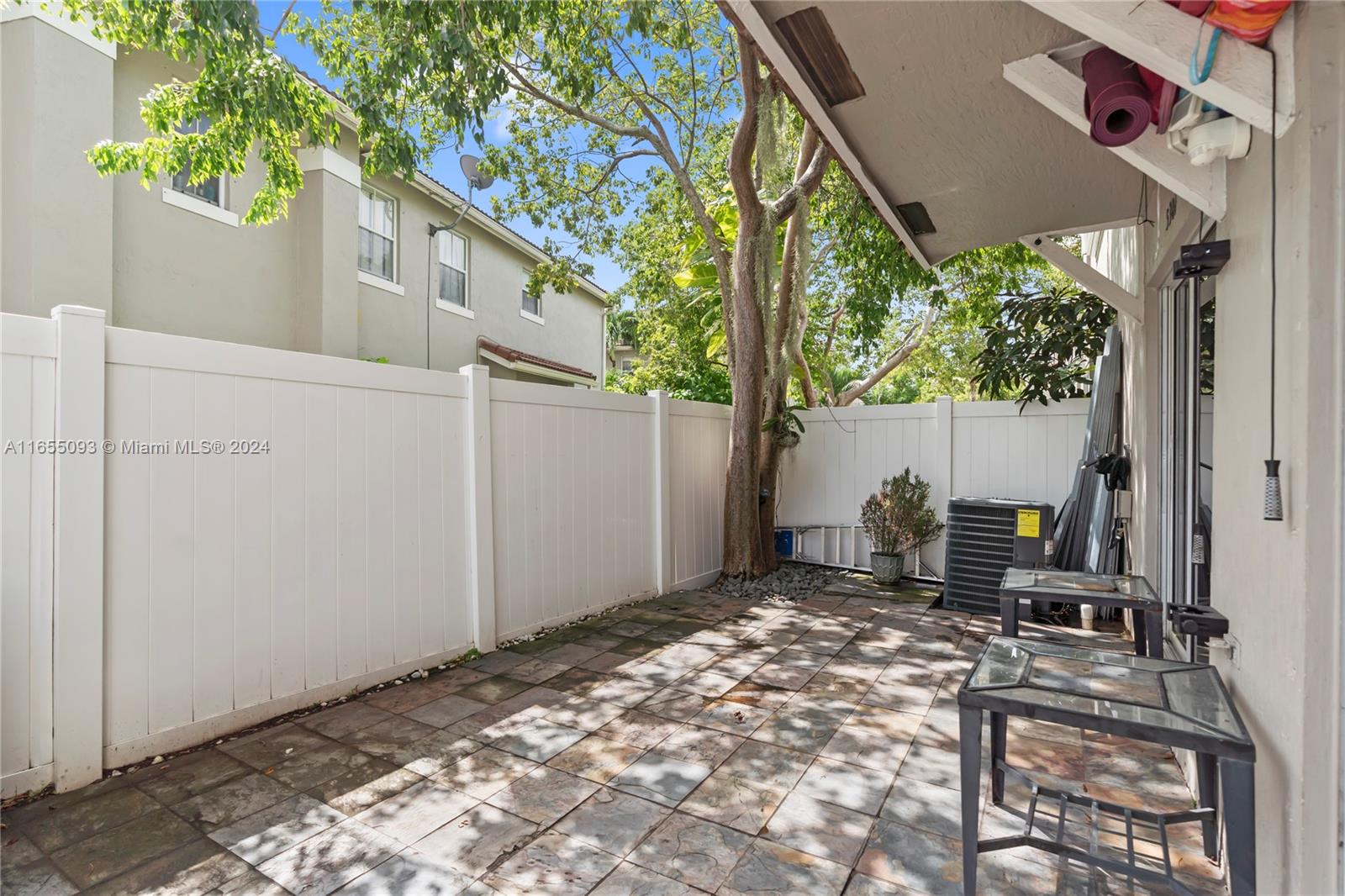 5301 Southwest 126th Terrace, Unit 5301 Miramar, FL 33027 - Photo 30 of 37 a backyard of a house with table and chairs