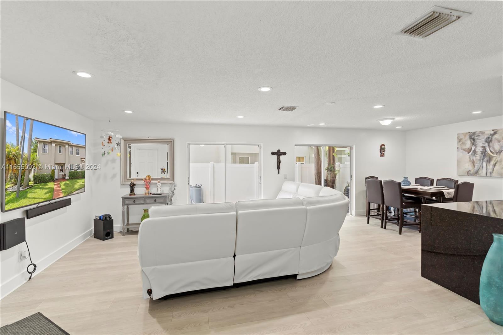 5301 Southwest 126th Terrace, Unit 5301 Miramar, FL 33027 - Photo 10 of 37 a living room with furniture and a flat screen tv