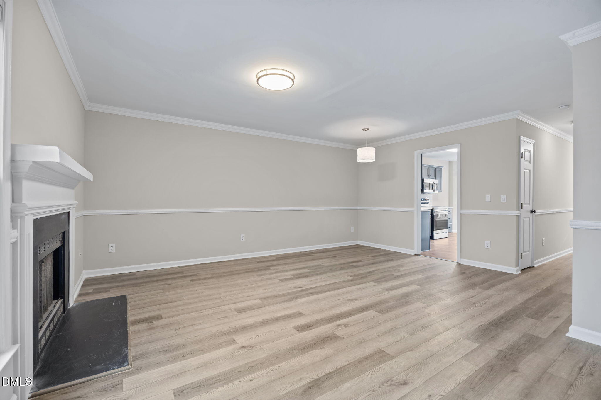 2813 Bedfordshire Court Raleigh, NC 27604 - Photo 7 of 46 a view of empty room with wooden floor and fireplace