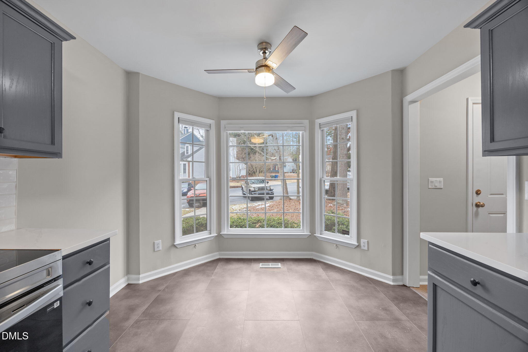 2813 Bedfordshire Court Raleigh, NC 27604 - Photo 11 of 46 a view of an empty room with a kitchen and a window