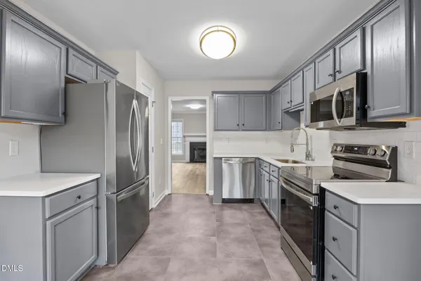 a view of a kitchen with furniture and an empty room