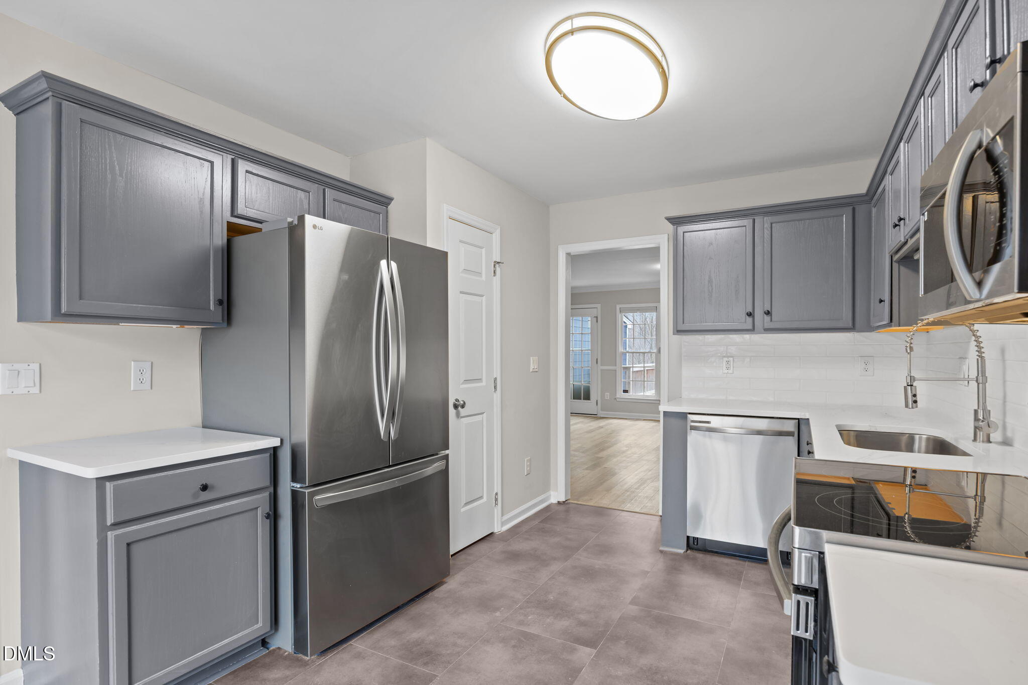 2813 Bedfordshire Court Raleigh, NC 27604 - Photo 14 of 46 a kitchen with stainless steel appliances granite countertop a refrigerator and a sink