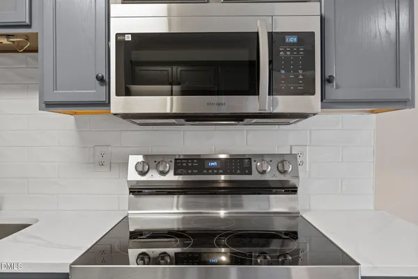 a kitchen with stainless steel appliances granite countertop a refrigerator stove and sink