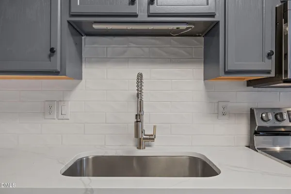 a kitchen with stainless steel appliances granite countertop a refrigerator stove and sink