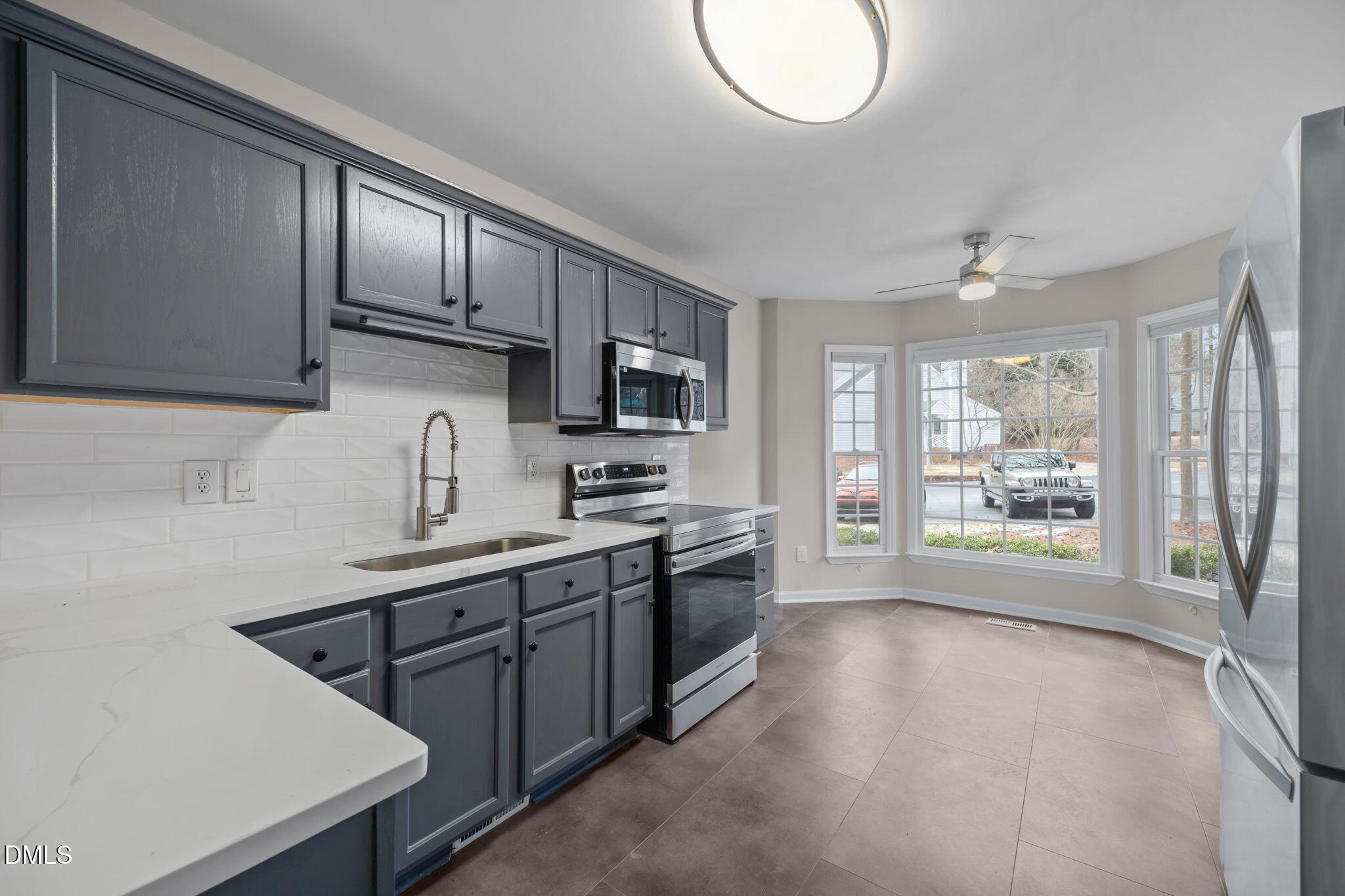 2813 Bedfordshire Court Raleigh, NC 27604 - Photo 17 of 46 a kitchen with stainless steel appliances a sink stove and cabinets