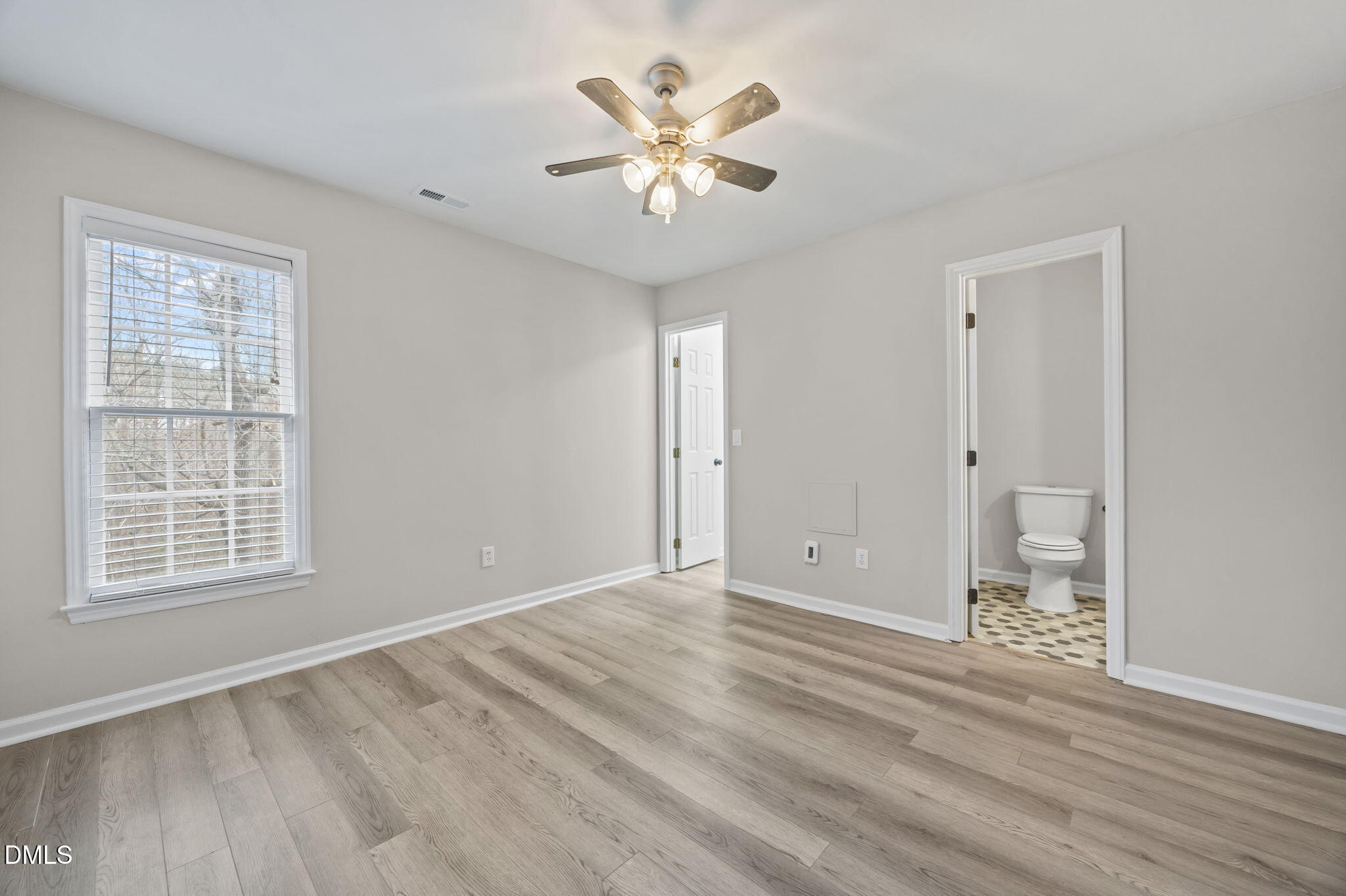 2813 Bedfordshire Court Raleigh, NC 27604 - Photo 22 of 46 wooden floor in an empty room with a window