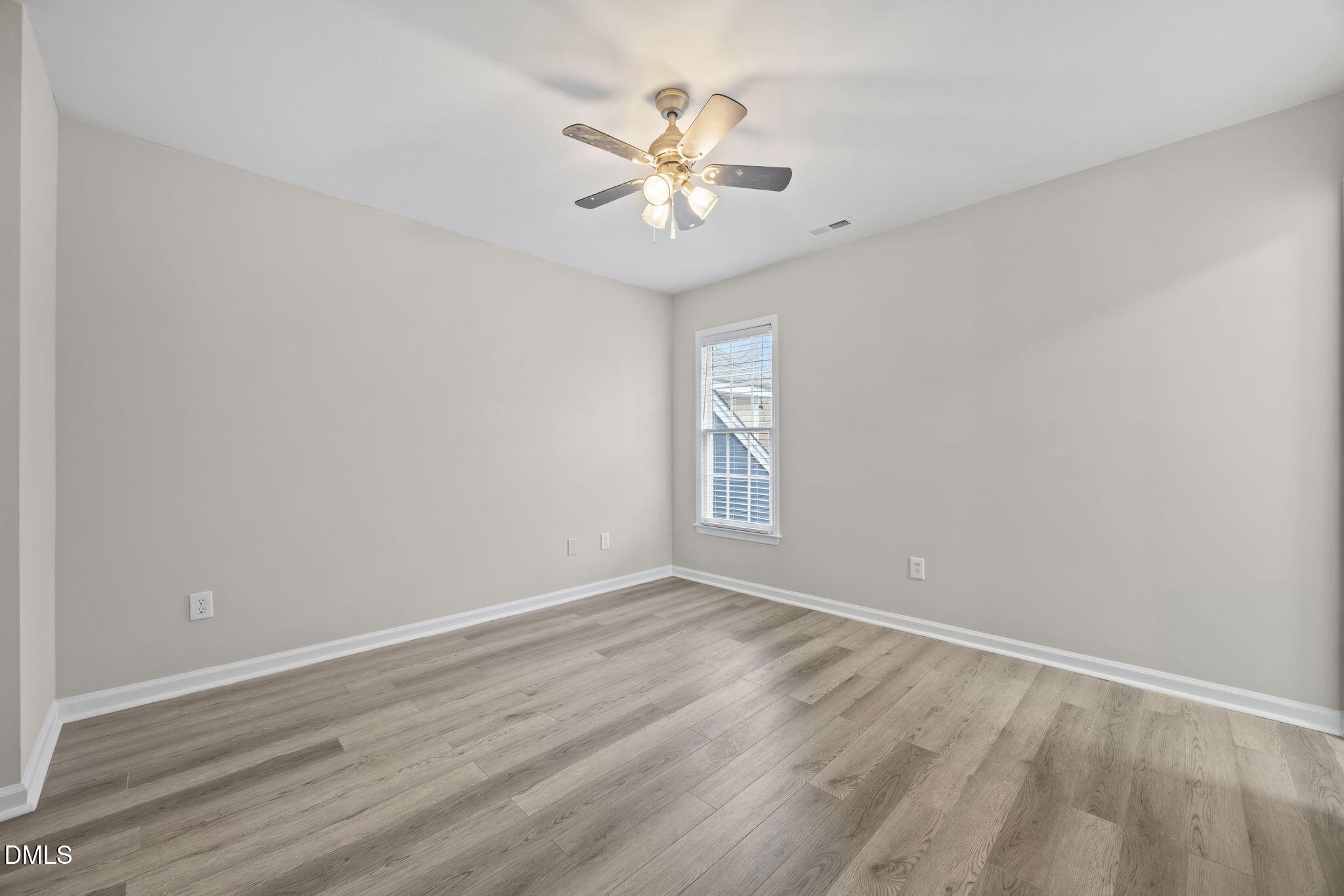 2813 Bedfordshire Court Raleigh, NC 27604 - Photo 23 of 46 wooden floor in an empty room with a window