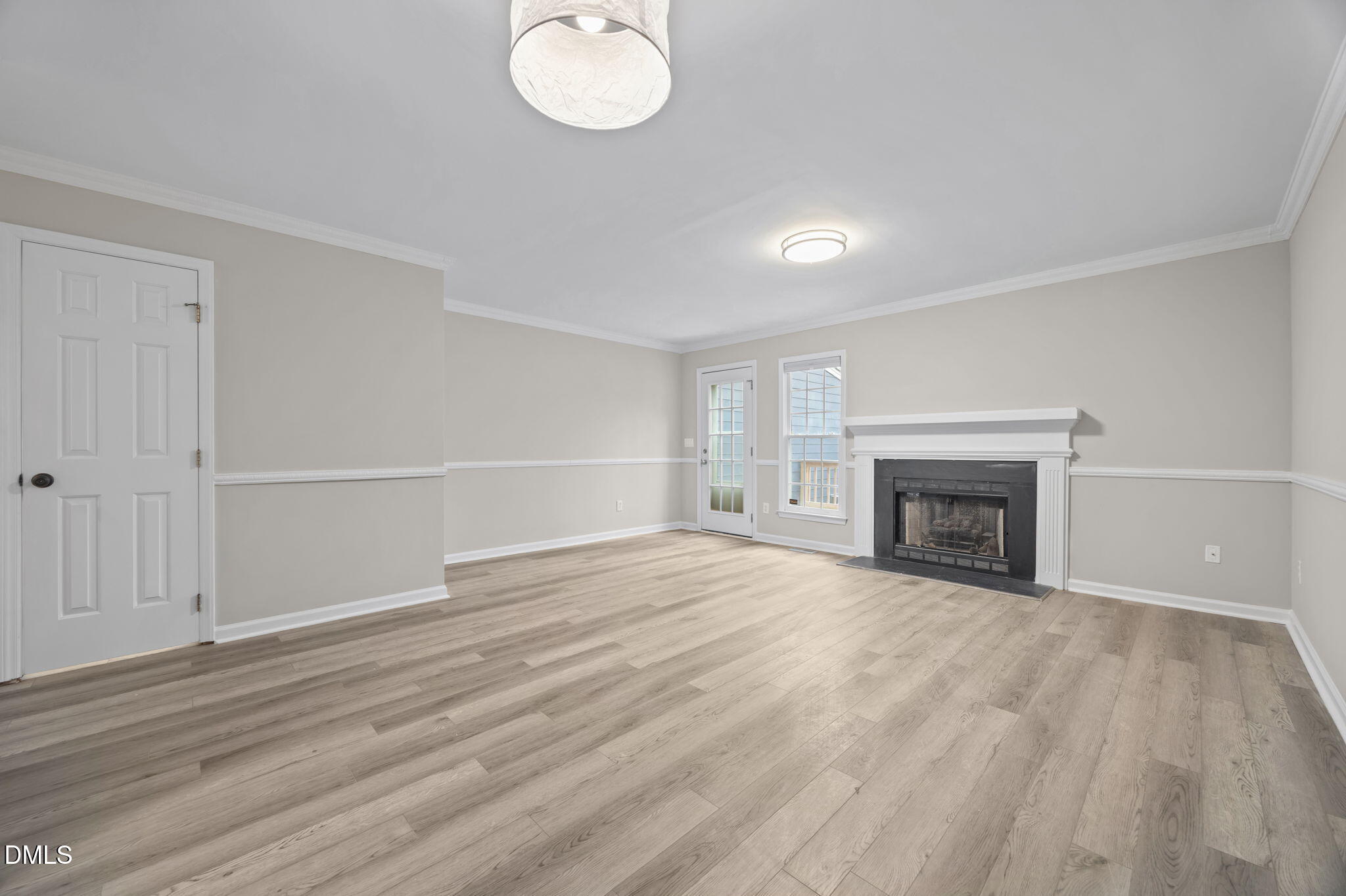2813 Bedfordshire Court Raleigh, NC 27604 - Photo 4 of 46 a view of empty room with wooden floor and fireplace