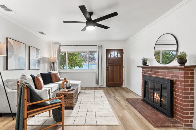 a living room with furniture a window and a fireplace