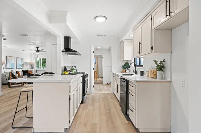 a kitchen with cabinets a sink and white appliances