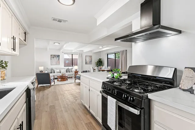 a kitchen with stove and cabinets