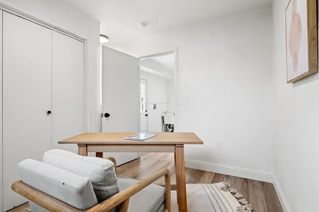 a living room with furniture wooden floor and a window